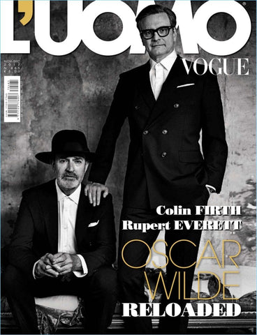 Cover of 'L'UOMO VOGUE' magazine featuring two men in suits, one sitting and the other standing, with the text 'Oscar Wilde Reloaded' and the names 'Colin Firth' and 'Rupert Everett' prominently displayed.
